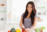 Beautiful woman cooking vegetables while standing