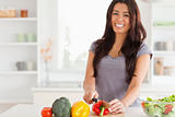 Gorgeous woman cooking vegetables while standing