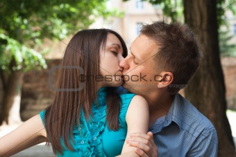 Love young couple kissing in the street