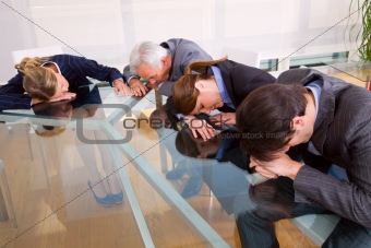 businessman and businesswoman exhausted during a meeting