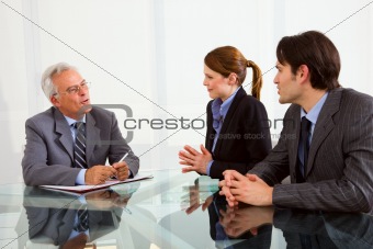 two men and one woman during a job interview