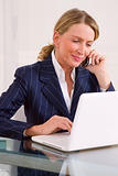 businesswoman in office with laptop