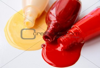 multi-colored nail polish  for hands spilled on a white background