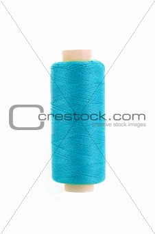 bobbin with blue thread over white background
