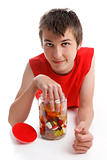 Boy with hand in lolly jar