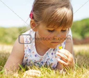 Little girl lying on grass in the park