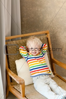 toddler lying in the chair