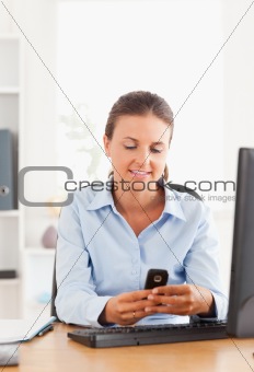 Office worker sending a text message