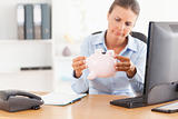 Office worker with an empty piggy bank