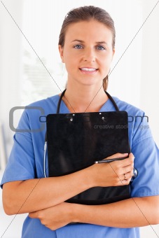 Close up of a nurse holding a folder
