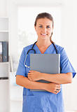 Doctor holding a folder and having a stethoscope around her neck