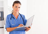 Doctor holding an open folder and having a stethoscope around her neck