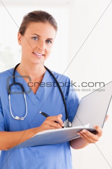 Gorgeous doctor with stethoscope and folder