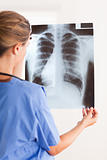 Doctor holding a x-ray having a stethoscope around her neck