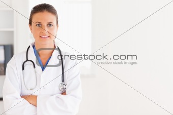 Charming doctor having a stethoscope around her neck looking into the camera