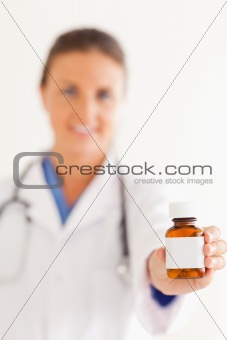 Close up of a cute doctor handing over some pills