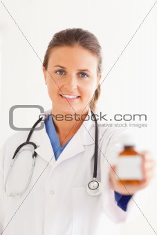 Portrait of a charming doctor handing over some pills