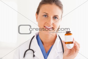 Portrait of a smiling doctor holding some pills