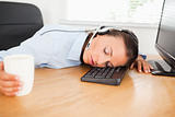 Businesswoman with headset sleeping in office