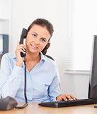 Telephoning businesswoman in an office 
