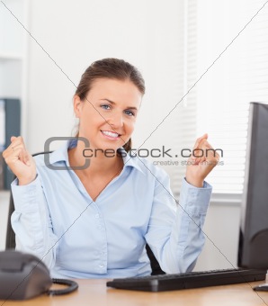 Happy businesswoman sitting in office