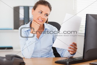 Charming businesswoman reading a paper