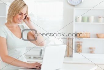 Woman with a laptop and a phone searching on the internet