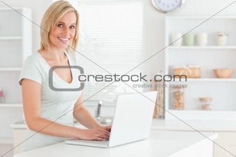 Charming woman with a laptop looking into the camera