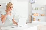 Woman with a cup of coffee and a laptop