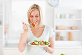 Gorgeous woman eating salad