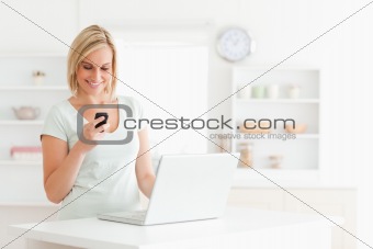 Cute woman with a mobile and a laptop