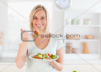 Close up of a gorgeous woman eating salad