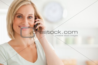Close up of a cute woman on mobile looking into the camera
