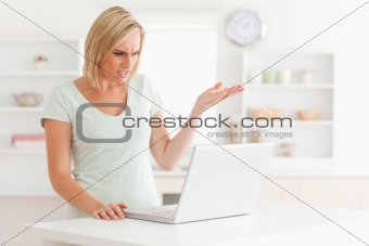 Upset woman looking at notebook without having any clue what to 