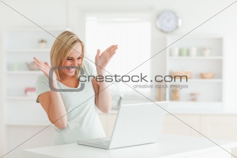 Laughing woman looking at laptop