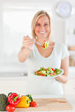 Young woman offering salad
