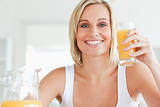 Woman toasting with orange juice