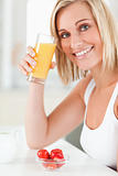 Woman toasting with glass of orange juice 