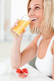 Woman drinking glass of orange juice 