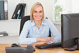Smiling woman sitting behind a desk