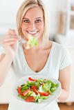 Charming woman offering salad