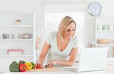 Woman looking for a recipe on laptop