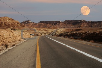 Narrow highway running through desert in Israel.