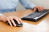 woman with hands on mouse and keyboard
