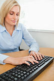 Typing woman looking at keyboard