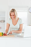 Blonde woman cutting peppers
