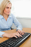 Typing woman looking at screen