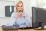 Smiling businesswoman with mobile looking into camera