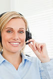 Smiling businesswoman with headset looking into camera