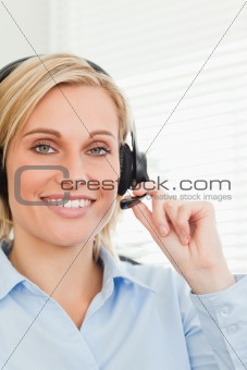 Smiling businesswoman with headset looking into camera